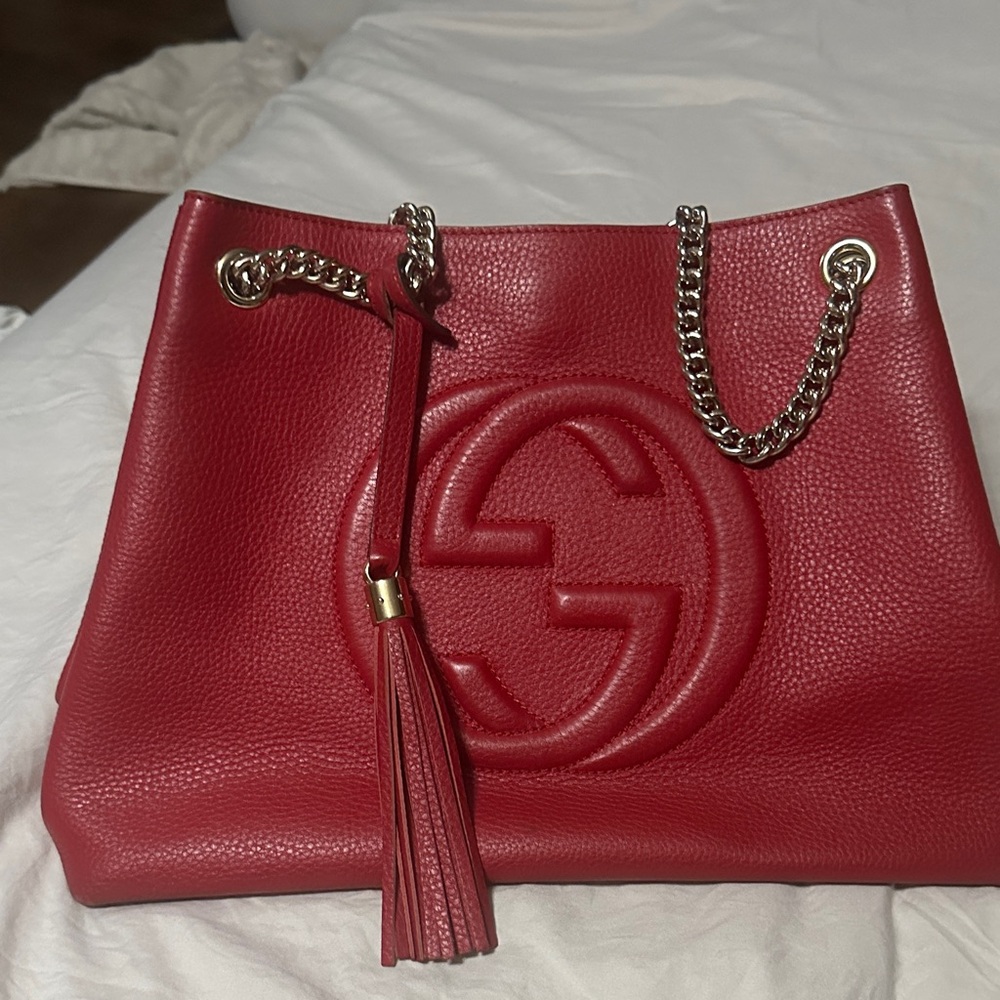 Pre owned Gucci Red Shoulder Bag with GoldHardware and Tassel Accents.
